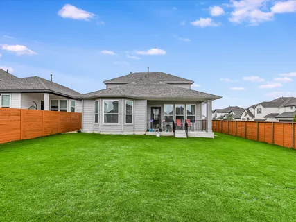 a view of a house with a yard and a lake view