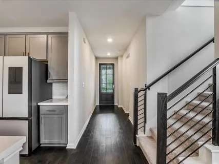 a view of hallway with stairs and wooden floor