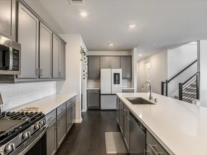 a kitchen with a sink stove and refrigerator