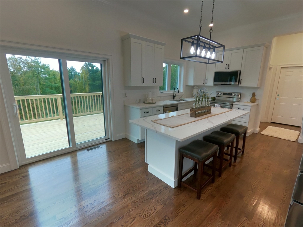 86 Berry Corner Road Charlton, MA 01507 - Photo 14 of 41 a view of kitchen with sink dining table and chairs