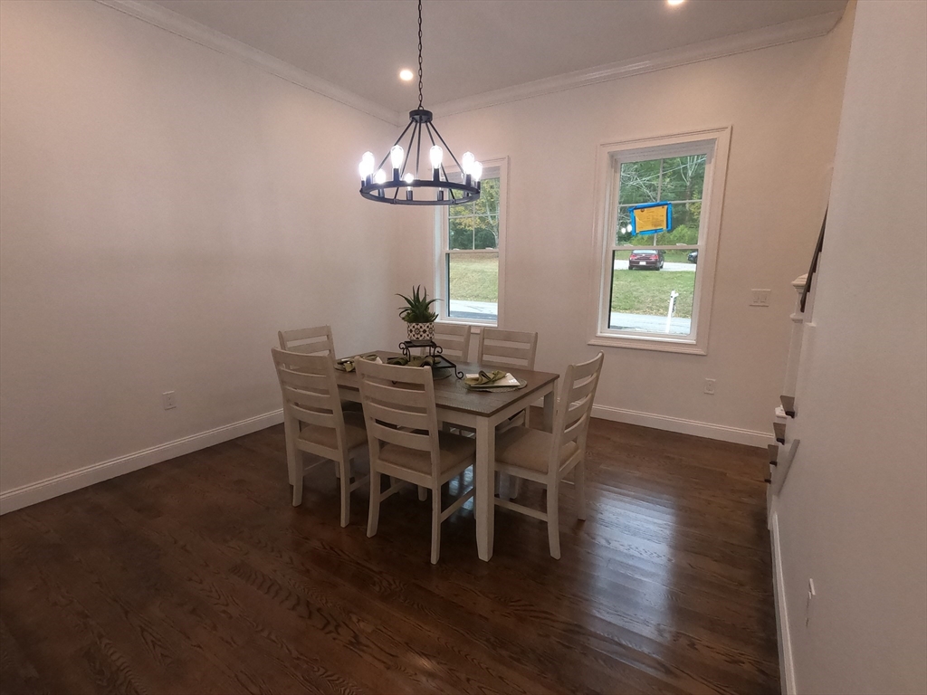 86 Berry Corner Road Charlton, MA 01507 - Photo 15 of 41 a view of a dining room with furniture and chandelier