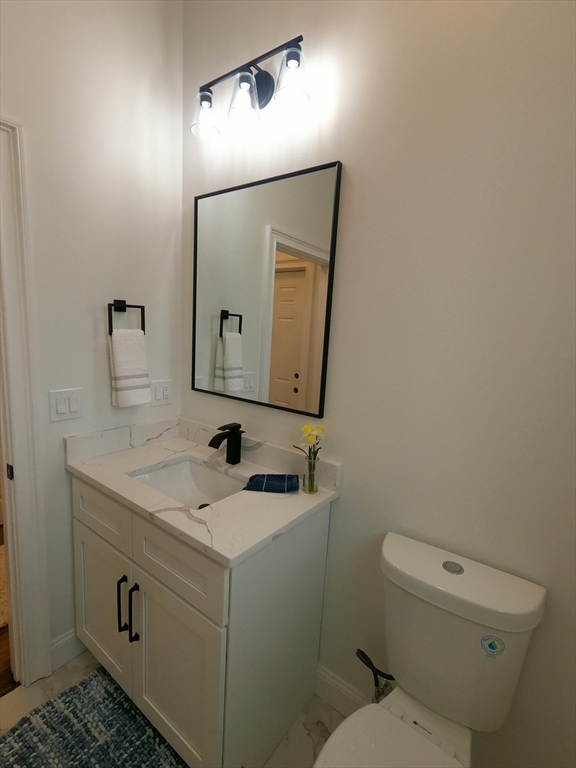 86 Berry Corner Road Charlton, MA 01507 - Photo 18 of 41 a bathroom with a toilet sink and mirror