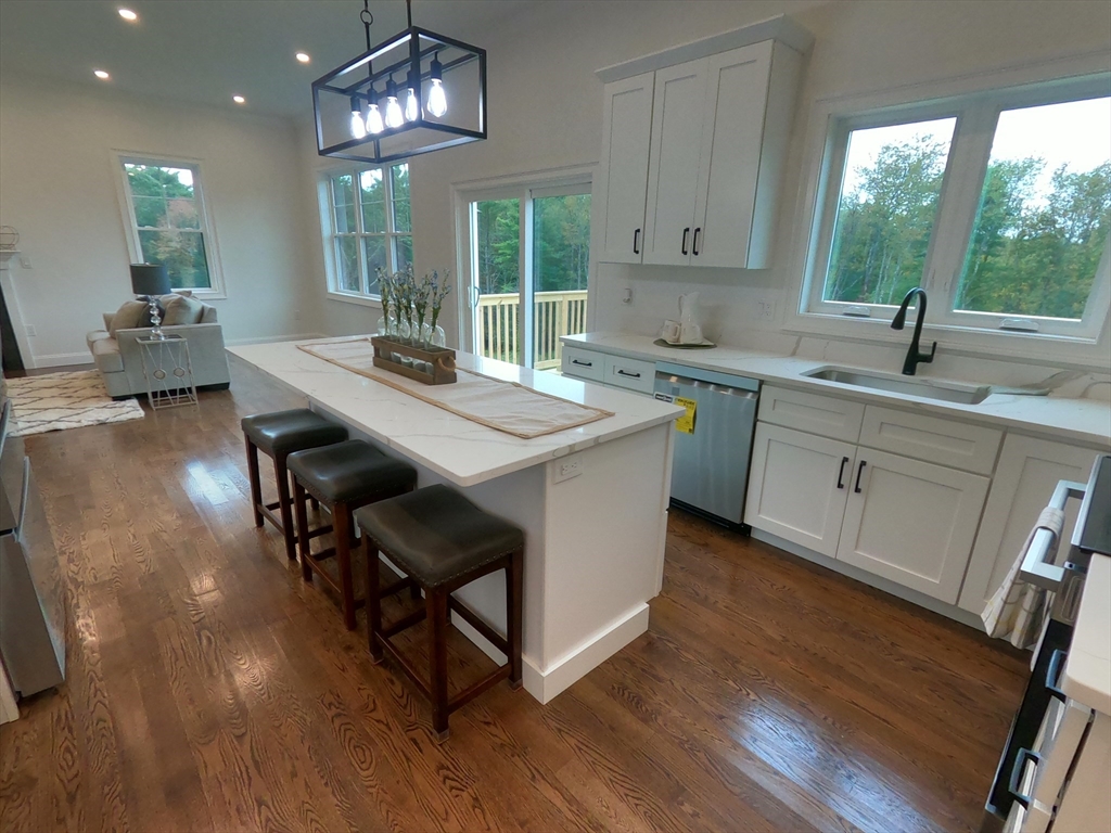 86 Berry Corner Road Charlton, MA 01507 - Photo 19 of 41 a kitchen with sink cabinets and wooden floor