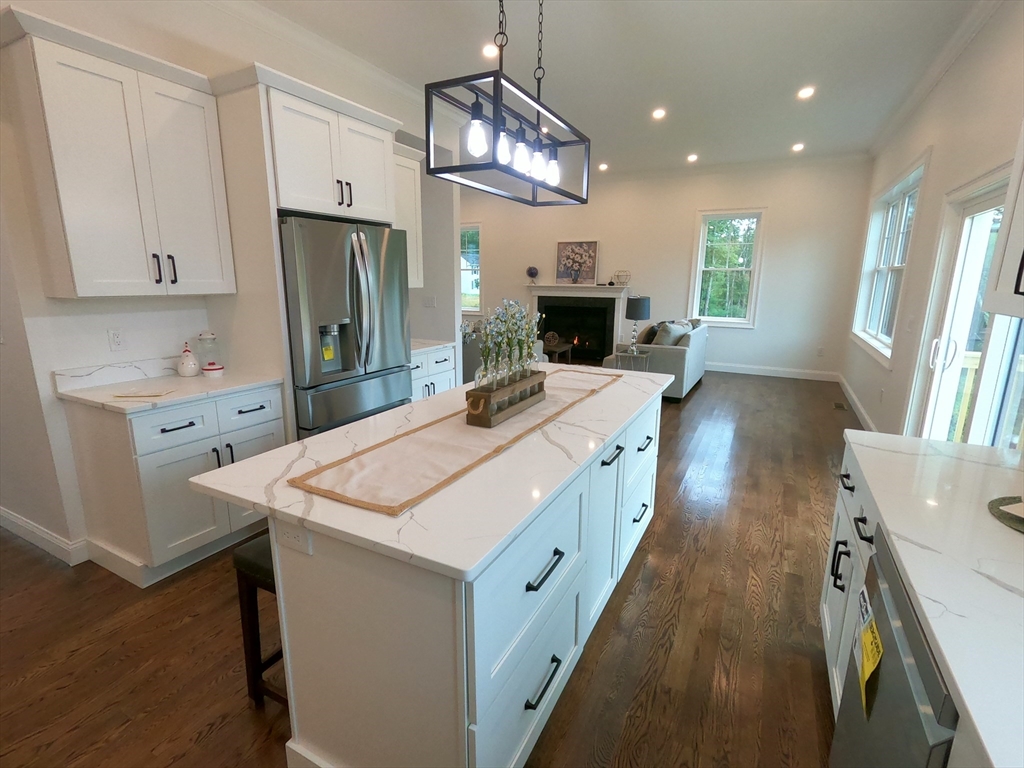 86 Berry Corner Road Charlton, MA 01507 - Photo 20 of 41 a large kitchen with kitchen island a refrigerator a stove a sink dishwasher and a dining table with wooden floor