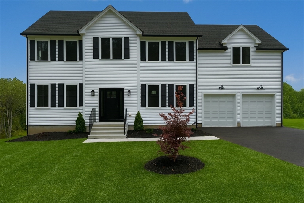 86 Berry Corner Road Charlton, MA 01507 - Photo 2 of 41 a front view of a house with a garden