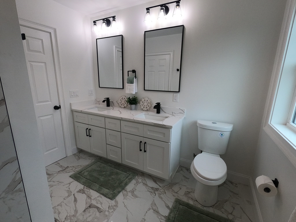 86 Berry Corner Road Charlton, MA 01507 - Photo 28 of 41 a bathroom with a toilet sink and mirror