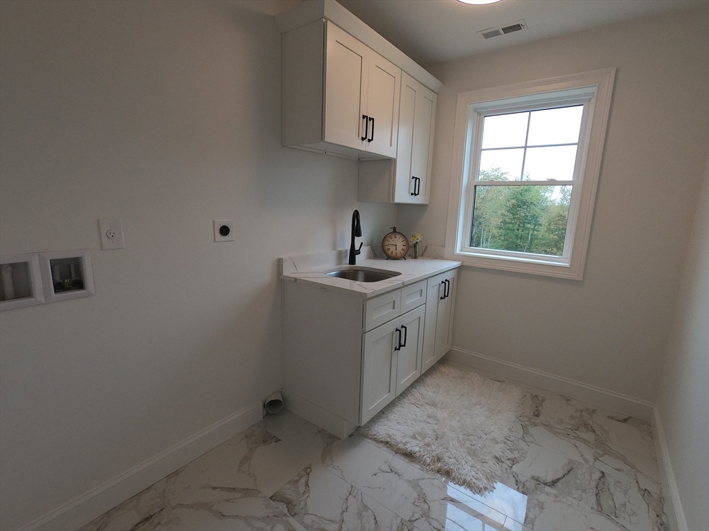 86 Berry Corner Road Charlton, MA 01507 - Photo 30 of 41 a room with a sink cabinets and window
