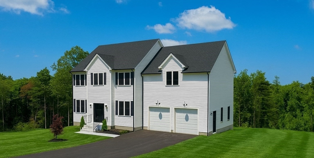 86 Berry Corner Road Charlton, MA 01507 - Photo 3 of 41 a view of a white house next to a yard with big trees