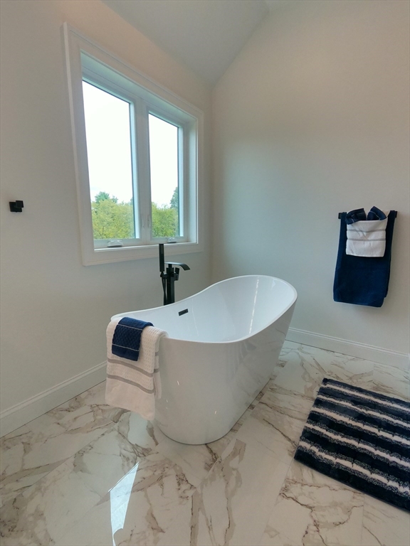 86 Berry Corner Road Charlton, MA 01507 - Photo 34 of 41 a bathroom with a bathtub and a window