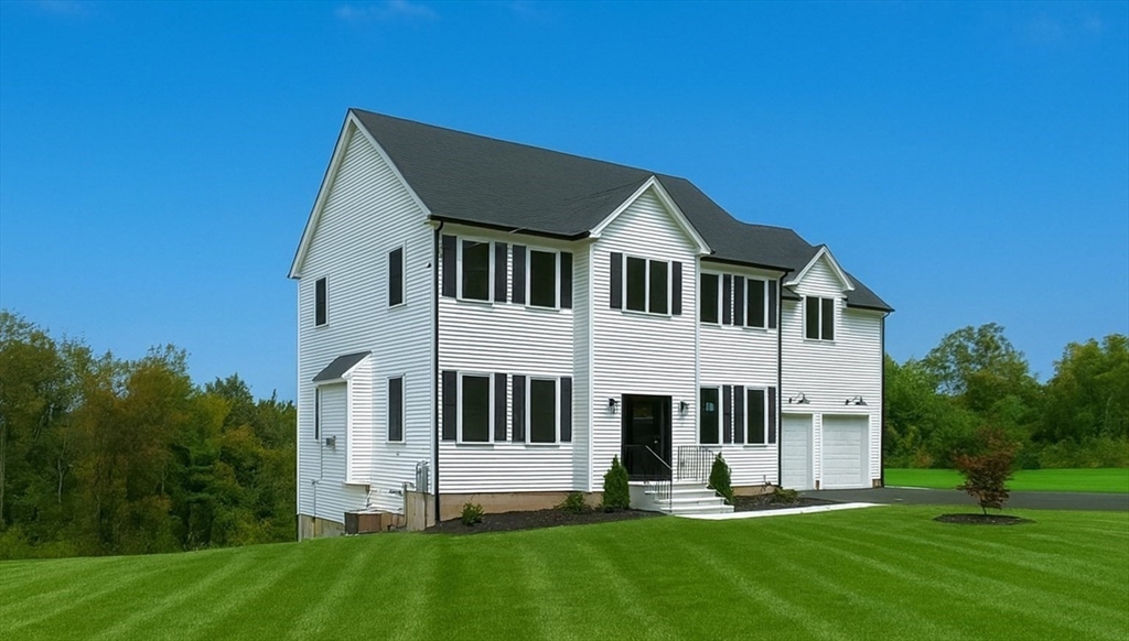 86 Berry Corner Road Charlton, MA 01507 - Photo 4 of 41 a house that is sitting in front of a big yard with large trees