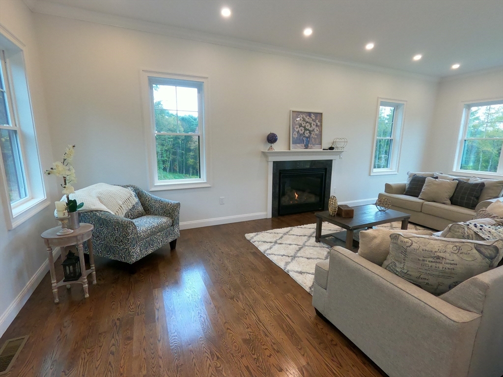 86 Berry Corner Road Charlton, MA 01507 - Photo 9 of 41 a living room with furniture and a fireplace