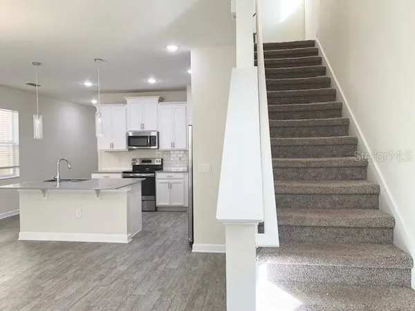 a kitchen with a refrigerator and a sink