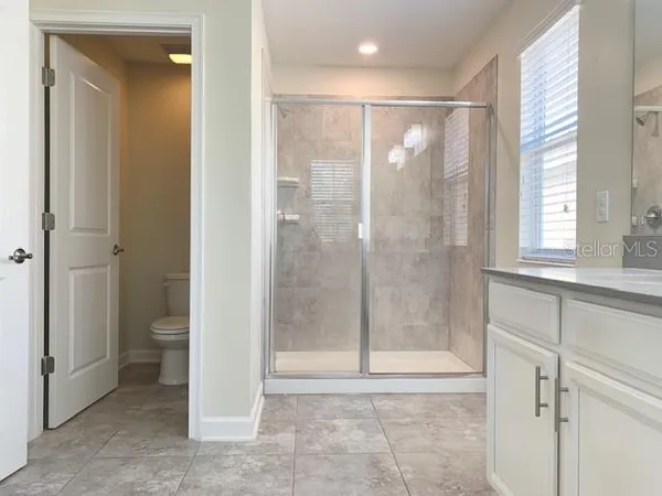 a bathroom with a glass shower door