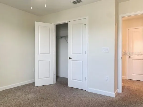 an empty room with closet area