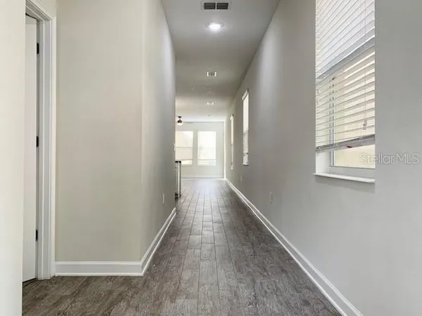 a view of hallway with wooden floor