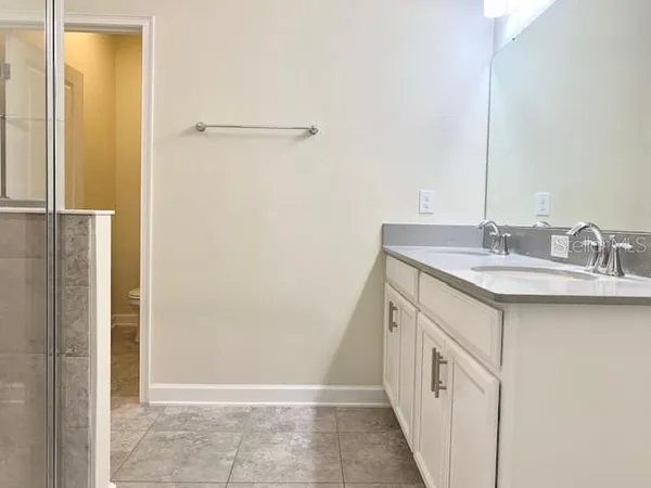 a bathroom with a sink a mirror and a shower