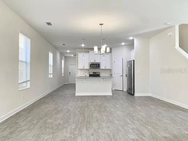 a view of kitchen with refrigerator and window