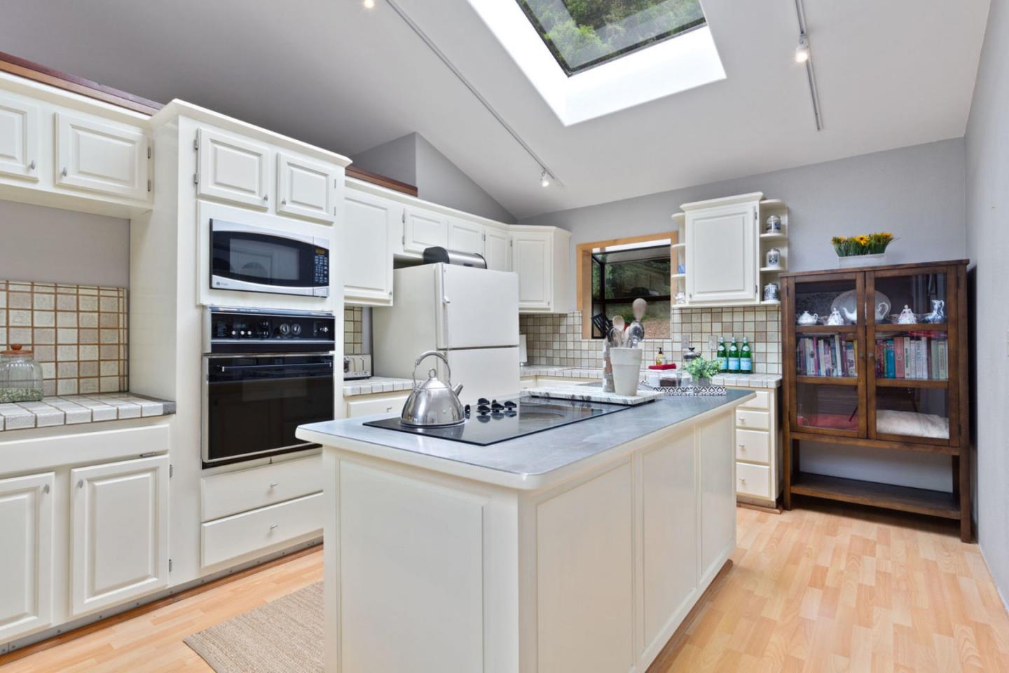 2060 Sparrow Valley Road Aptos, CA 95003 - Photo 13 of 45 a kitchen with stainless steel appliances kitchen island granite countertop a refrigerator and stove