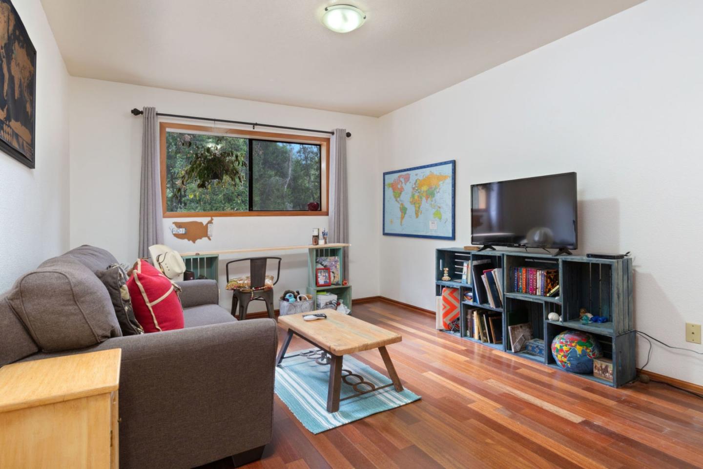 2060 Sparrow Valley Road Aptos, CA 95003 - Photo 28 of 45 a living room with furniture a bookshelf and a flat screen tv