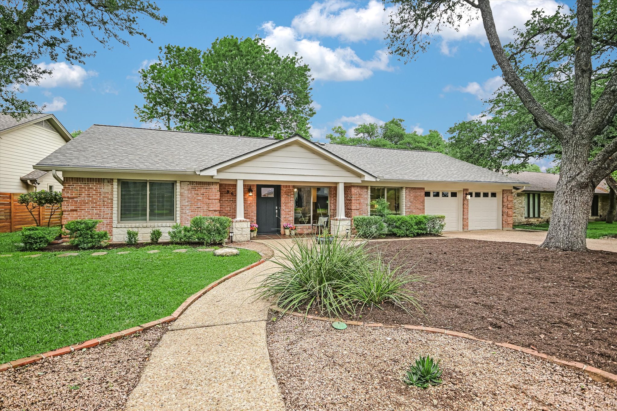 Framed by majestic oaks, this timeless brick-and-stone home in picturesque Westover Hills has been cherished by the same family since its construction in 1969.