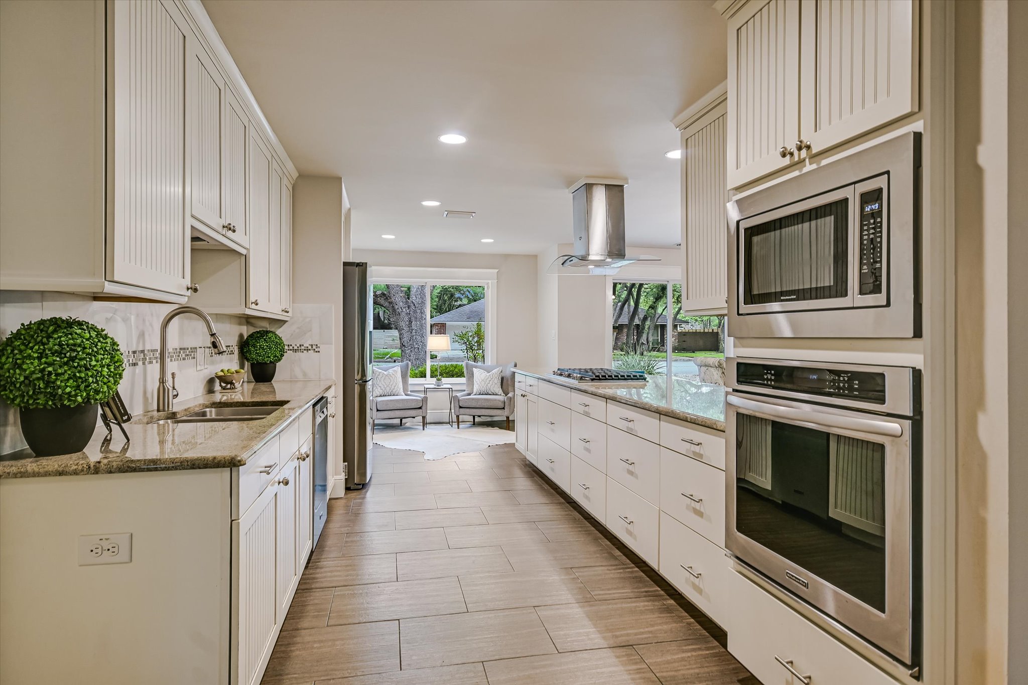 8602 Silver Ridge Drive Austin, TX 78759 - Photo 9 of 40 The kitchen is equipped with a built-in KitchenAid oven and microwave, along with a new (April 2026) five-burner gas cooktop.