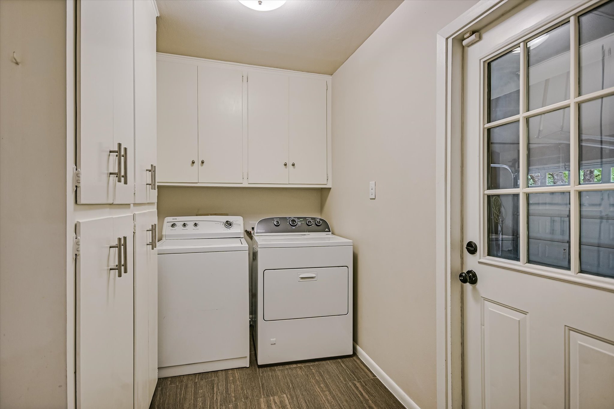 8602 Silver Ridge Drive Austin, TX 78759 - Photo 23 of 40 The utility room provides storage with upper cabinetry and a floor-to-ceiling pantry cabinet.