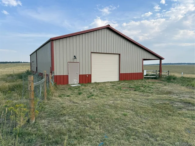 a view of empty room with wooden walls