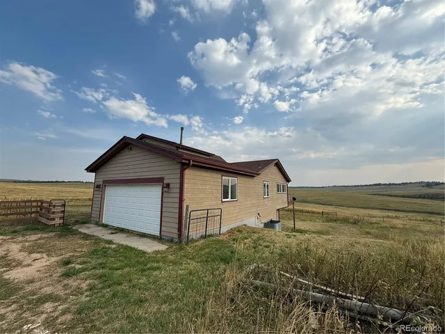 a view of a living room and kitchen with a large window