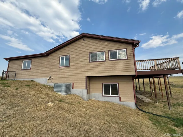 a view of a house with wooden fence