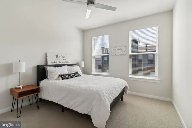 a bedroom with a bed chair and window