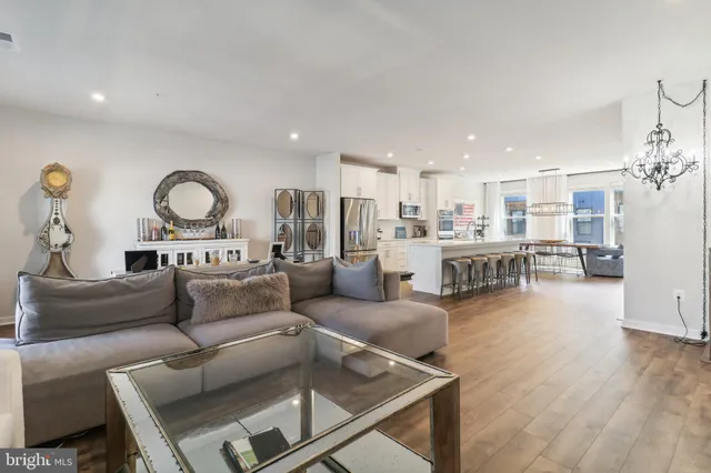a living room with furniture and kitchen view