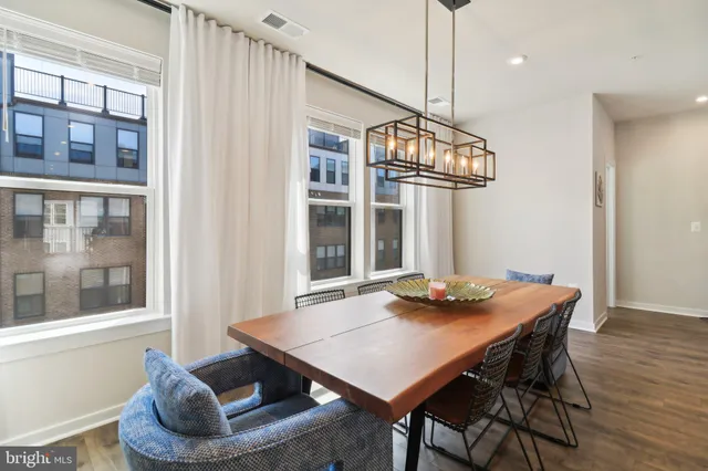 a view of a dining room with furniture wooden floor and chandelier