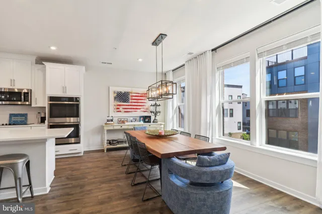 a dining room with furniture and wooden floor