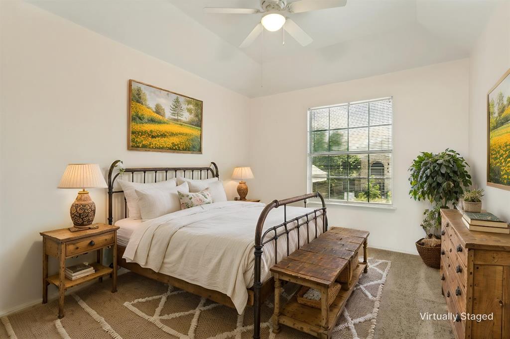 4107 Waverly Road Corinth, TX 76208 - Photo 20 of 30 One of three upstairs bedrooms, this one overlooks the front yard, features a raised ceiling height, soft neutral wall color, ceiling fan, neutral carpet and ample closet space.