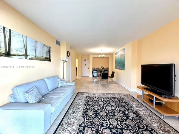 a living room with couch and a flat screen tv