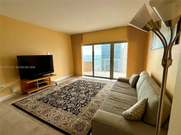 a living room with furniture and a flat screen tv