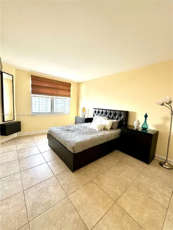a spacious bedroom with a bed and a table in it
