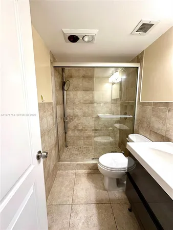 a bathroom with a sink mirror toilet and shower
