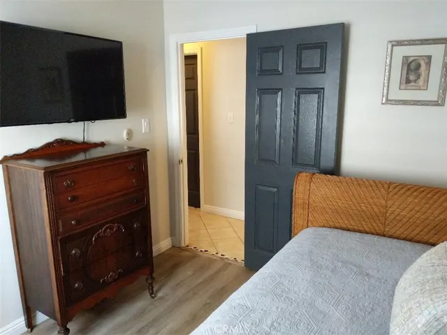 a bedroom with a bed and flat screen tv