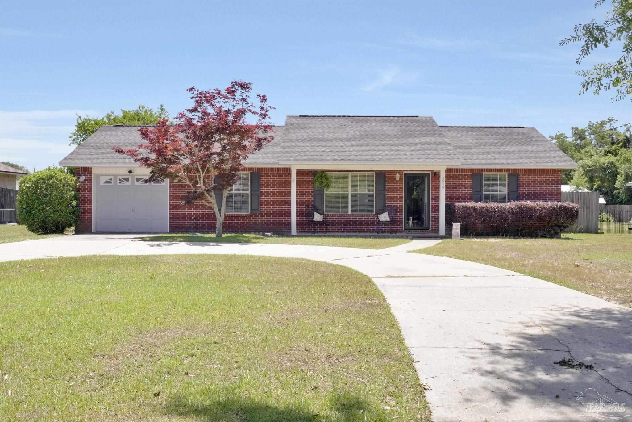 5539 Windrun Place Pace, FL 32571 - Photo 52 of 62 a front view of house with yard and trees in the background