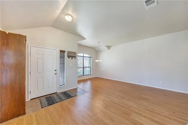 a view of an empty room and wooden floor