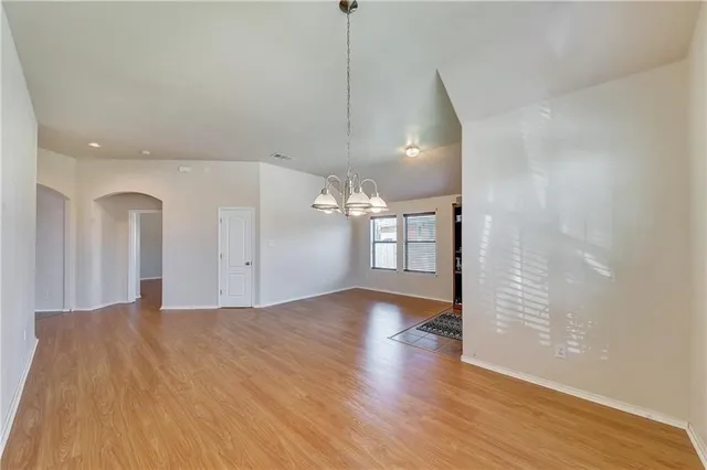 a view of a room with wooden floor