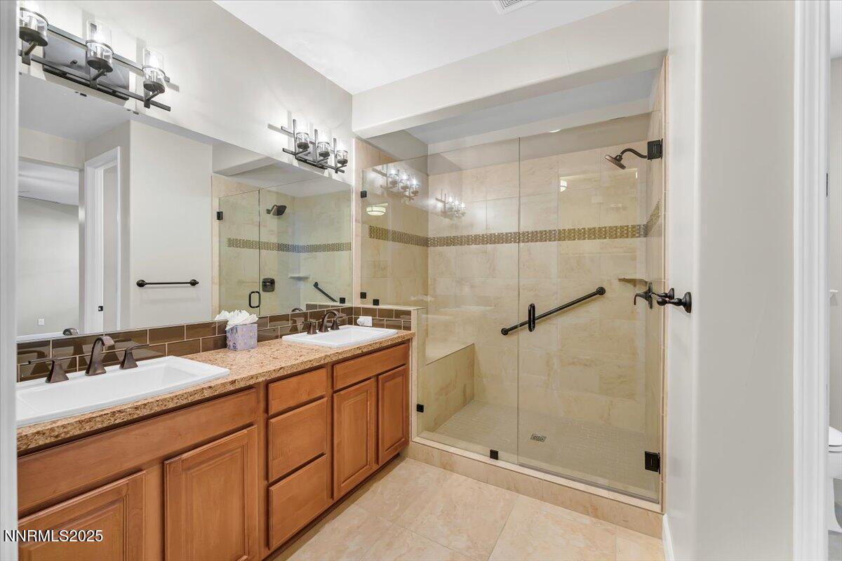 320 Mt Rose Street Reno, NV 89509 - Photo 17 of 32 a bathroom with a double vanity sink mirror and shower