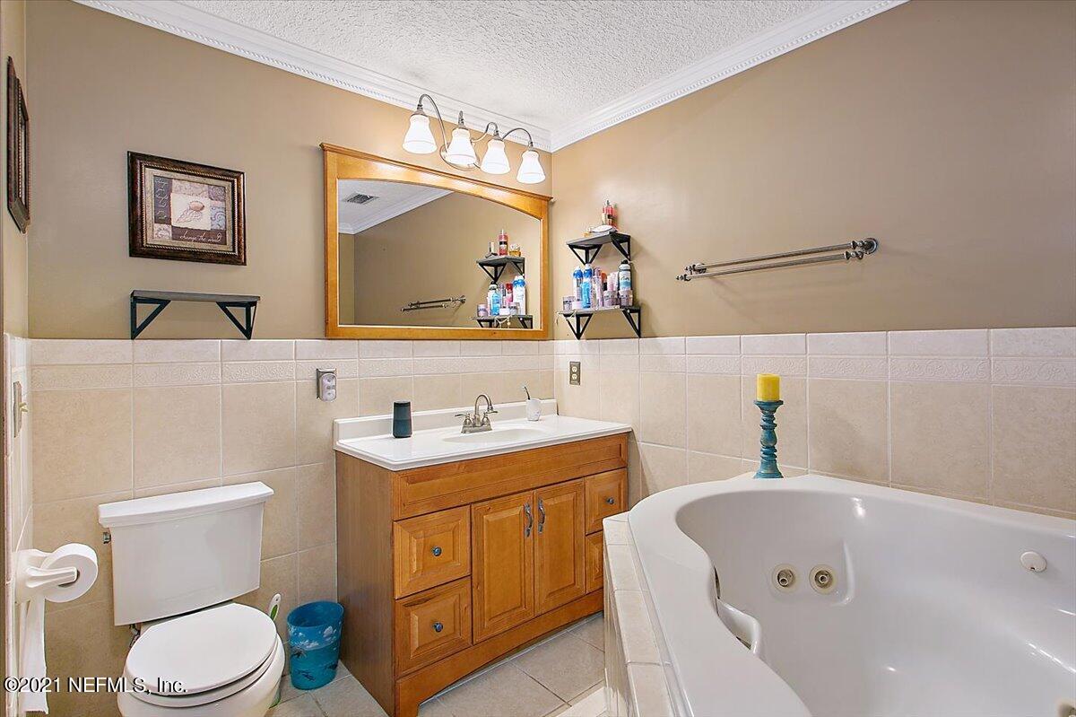 1281 Cutlass Road Orange Park, FL 32065 - Photo 11 of 21 a bathroom with a sink a toilet and vanity