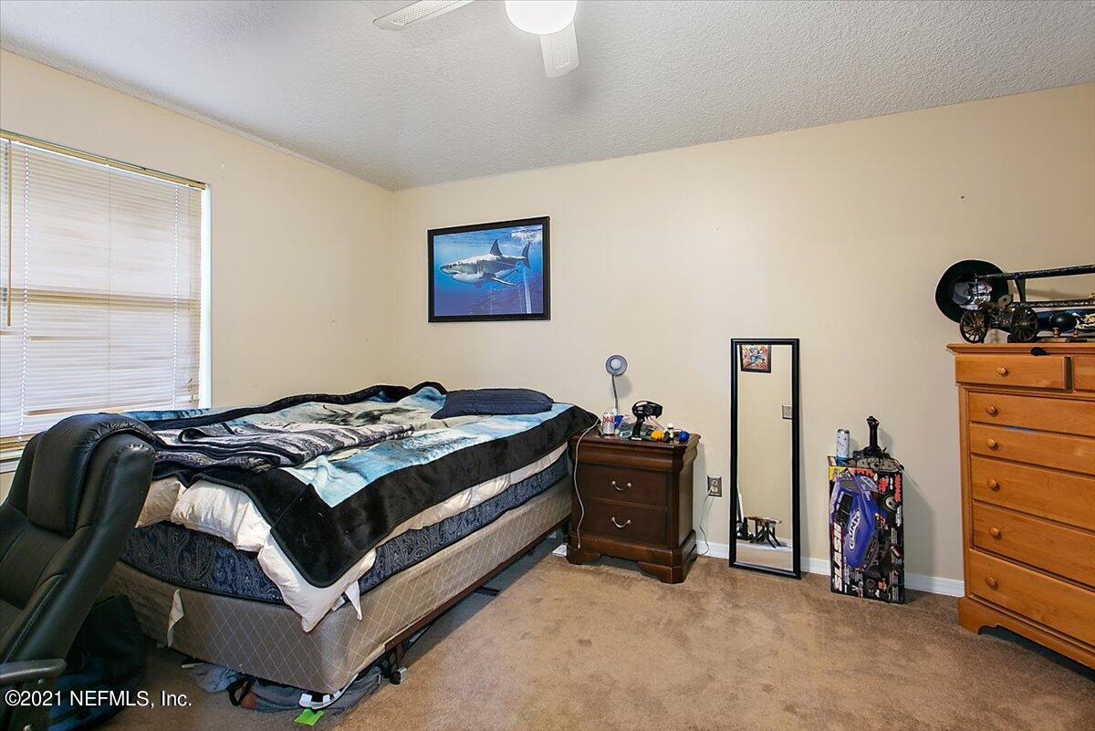 1281 Cutlass Road Orange Park, FL 32065 - Photo 13 of 21 a bedroom with a bed and a desk