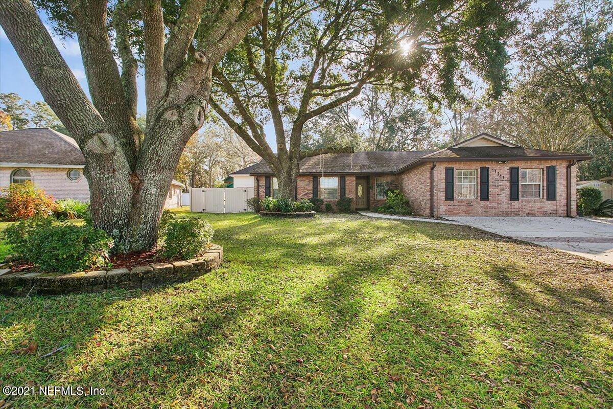 1281 Cutlass Road Orange Park, FL 32065 - Photo 21 of 21 a front view of a house with a garden and trees