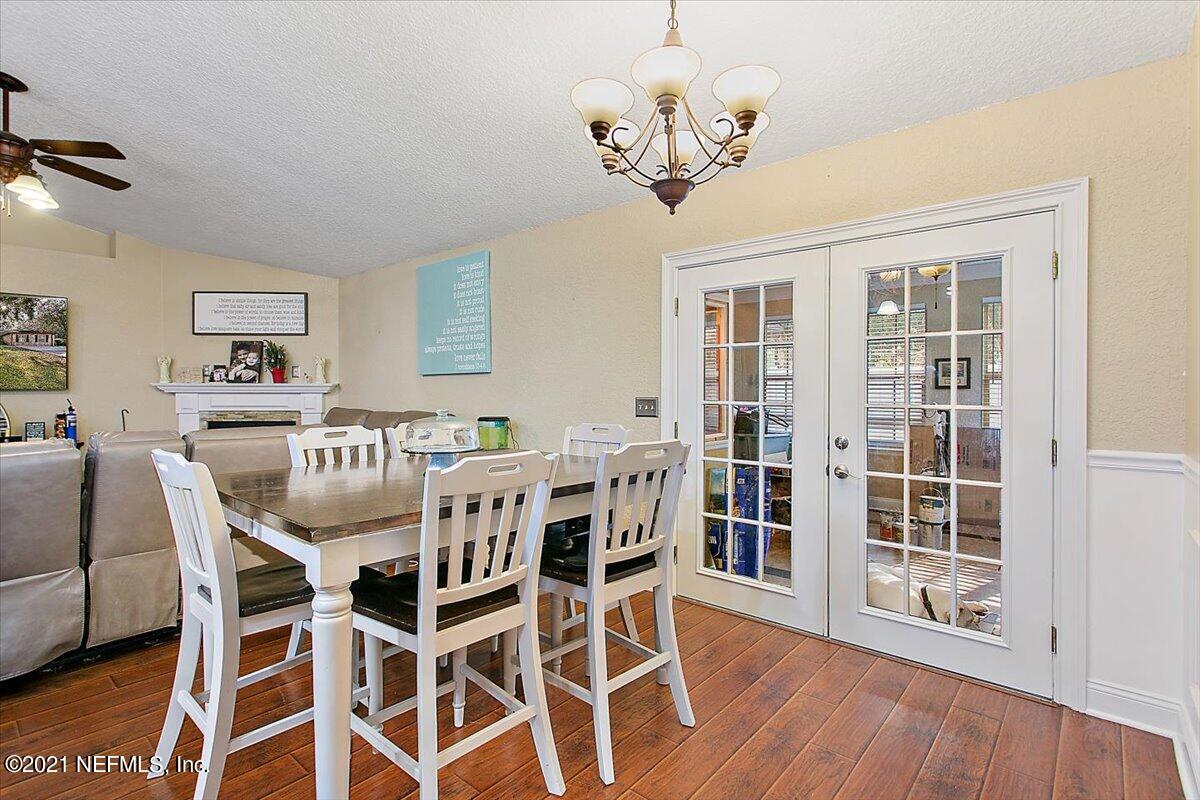 1281 Cutlass Road Orange Park, FL 32065 - Photo 5 of 21 a view of a dining room with furniture wooden floor and chandelier