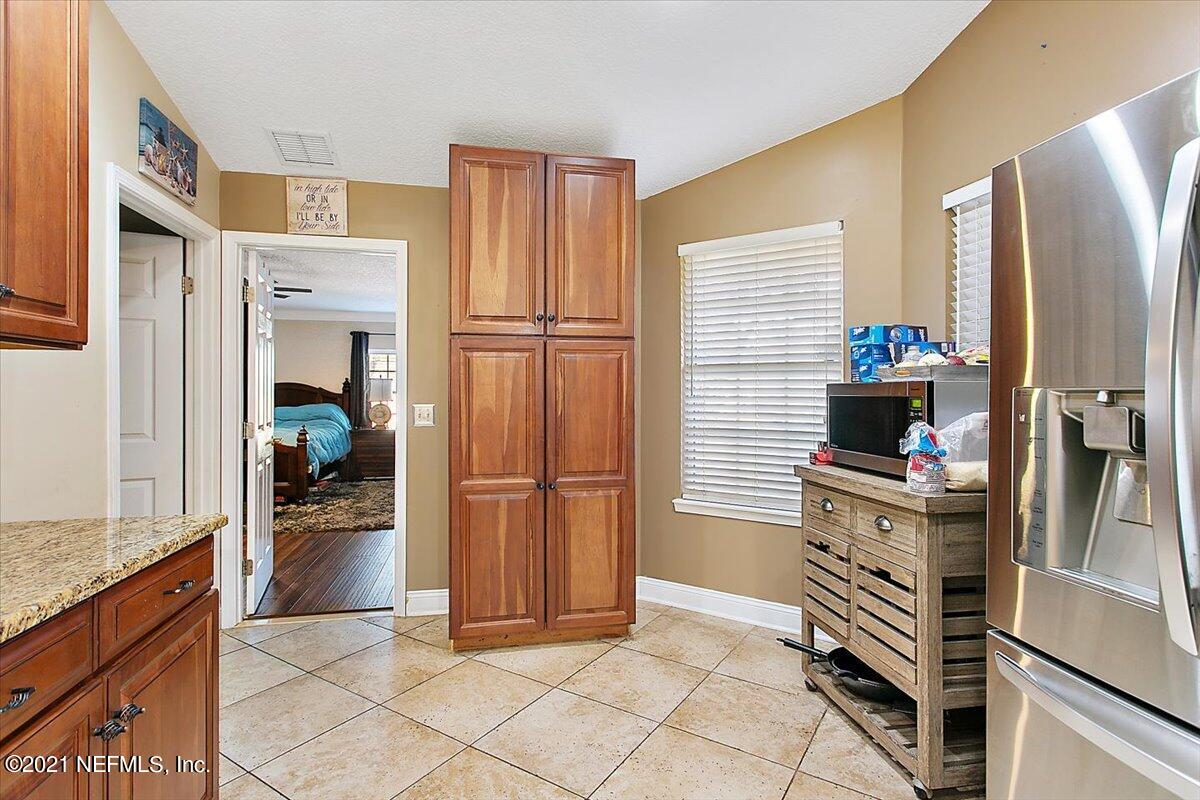 1281 Cutlass Road Orange Park, FL 32065 - Photo 8 of 21 a kitchen with stainless steel appliances granite countertop a refrigerator and a stove