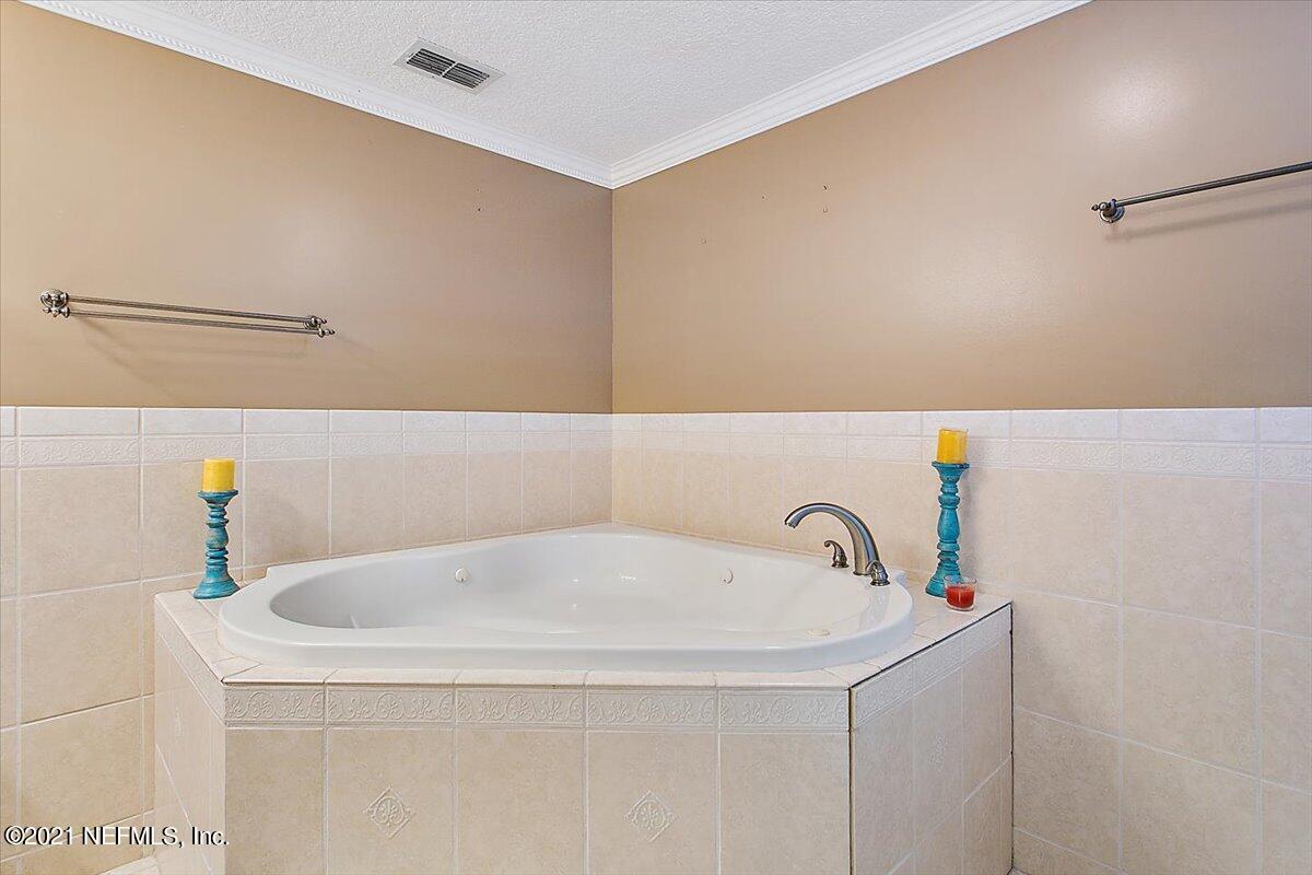 1281 Cutlass Road Orange Park, FL 32065 - Photo 10 of 21 a bathroom with a white bath tub and shower
