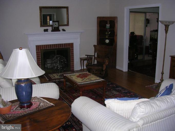 1303 Ruppert Road Silver Spring, MD 20903 - Photo 2 of 11 a living room with furniture and a fireplace